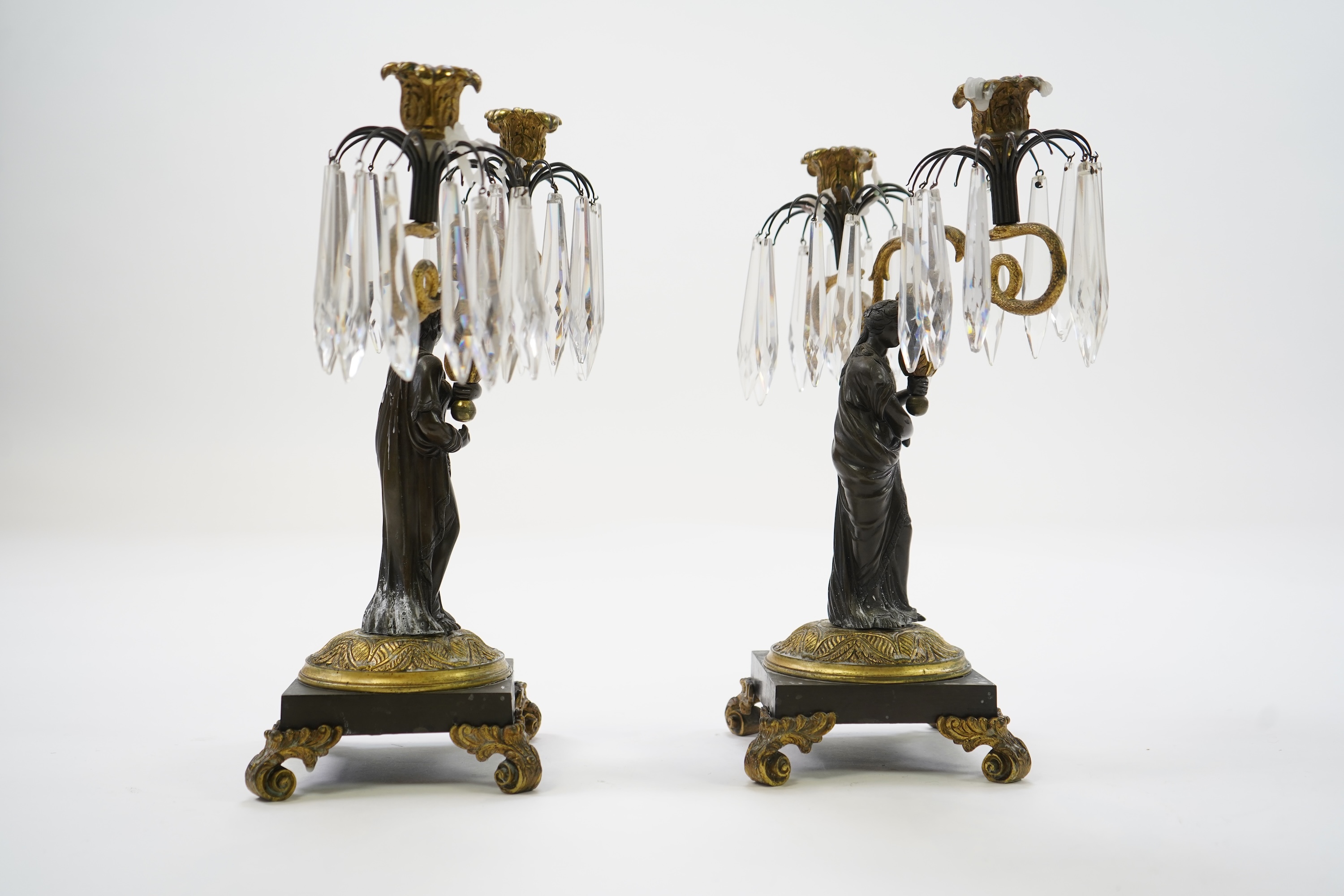 After Mathurin Moreau. A pair of mid 19th century bronze and gilt bronze two branch candelabra